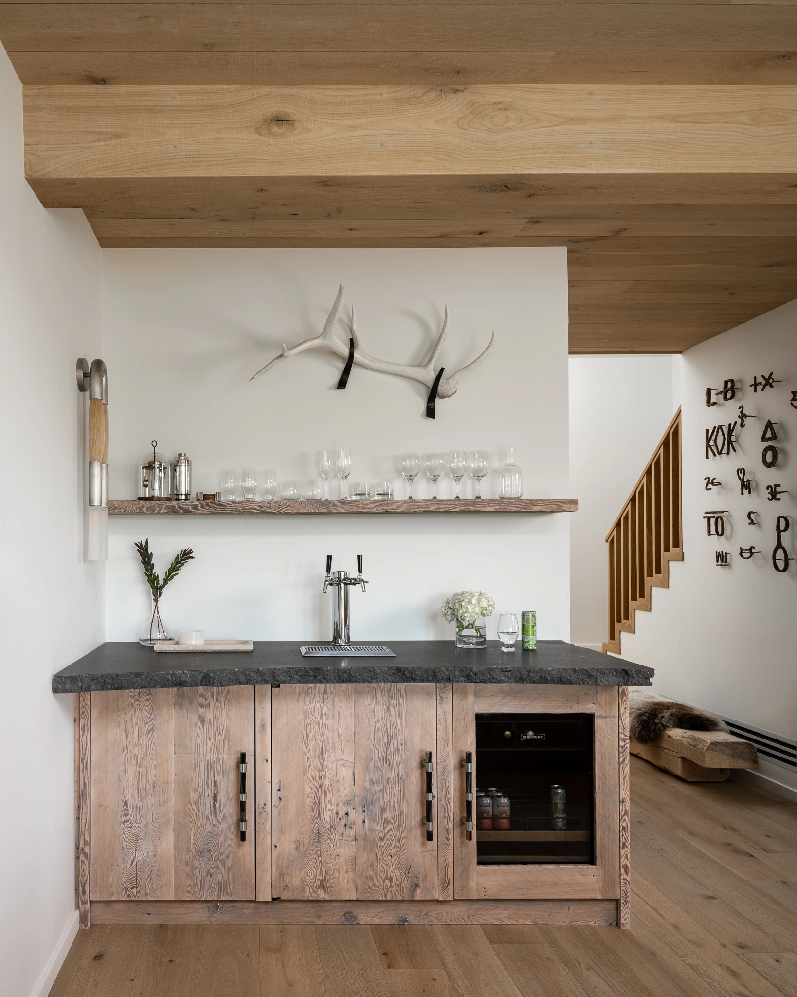 Wet bar with reclaimed wood cabinetry and antler decor — Dry Creek Ranch, Design Republic Interiors; Southwest Montana editorial interior photography
